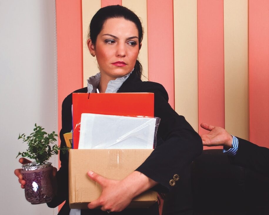 Woman manager walks out on her boss with her possessions in a cardboard box