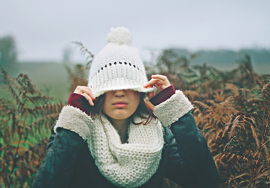 Girl wearing a woolly hat covering her eyes