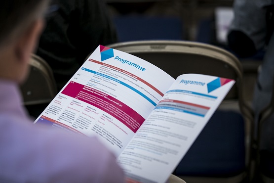 Member reading an MiP Summit programme