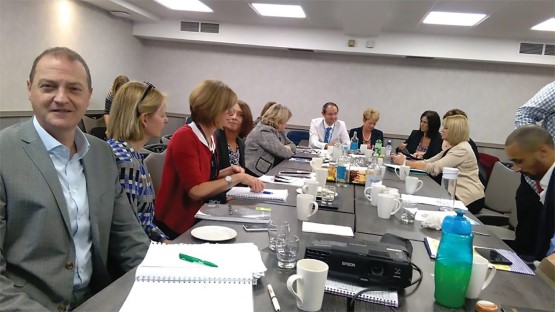 National Social Partnership Forum (SPF) members in a meeting sitting around a table