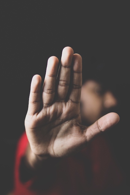 Woman's hand giving STOP gesture