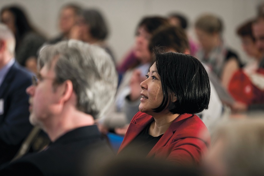 Audience listening at union meeting