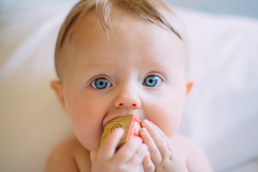 Baby close up with toy in mouth