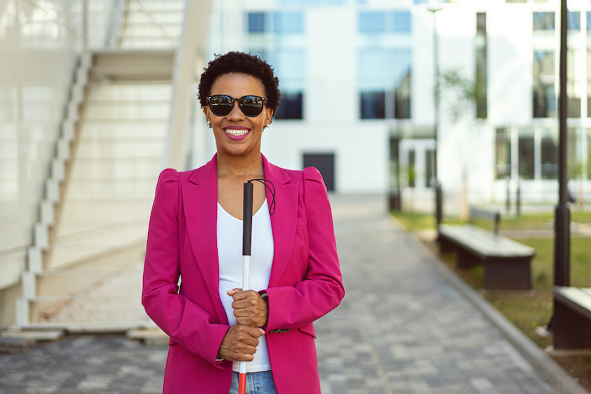 Blind woman manager outside corporate office building