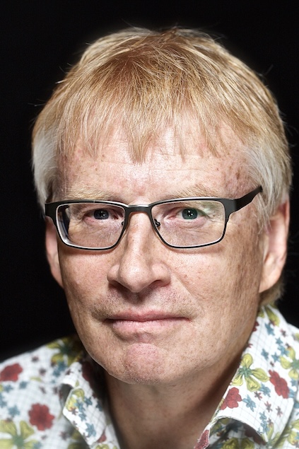 headshot of Dr Phil Hammond in a flowery shirt, 2024