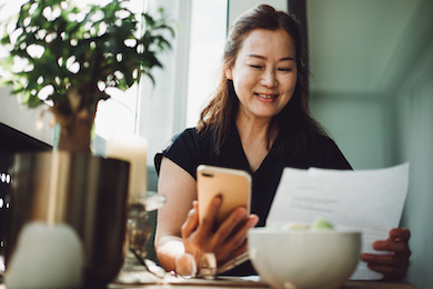 Woman working in a cafe with phone