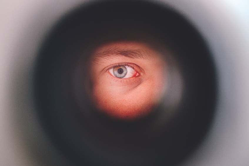 Close up of eye viewed through spyhole